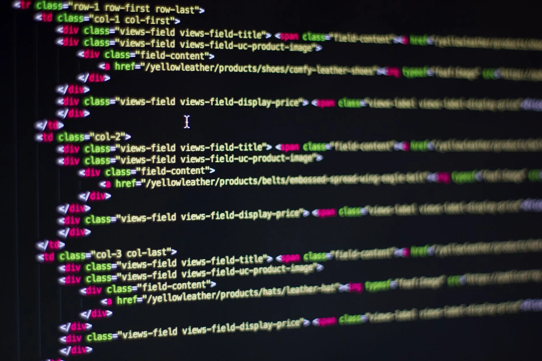 Software engineer analyzing website code structure and technical server logs on multiple monitors